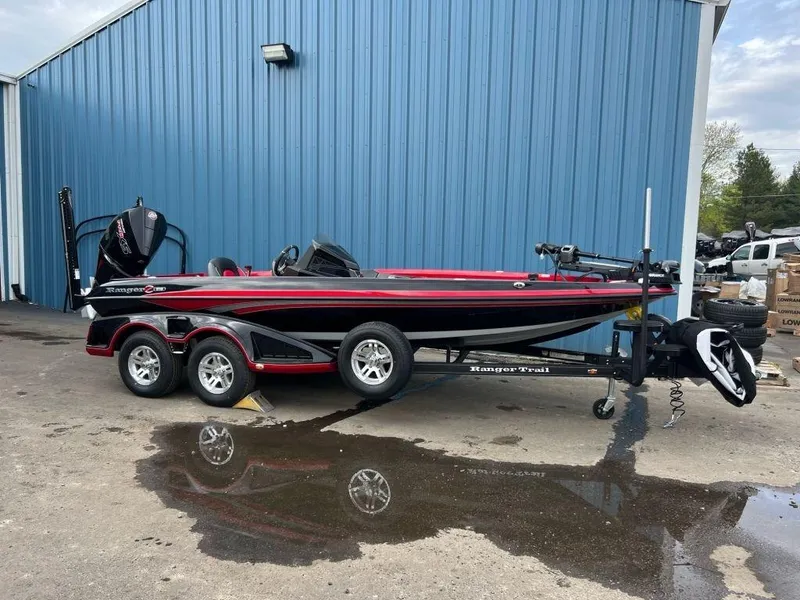 The Image of 2023 Ranger Z519 boat on trailer outside blue building. - 1