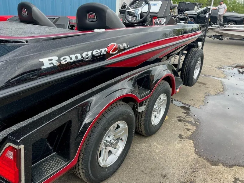 Slide: The Image of 2023 Ranger Z519 boat with dual-axle trailer, black and red design. - 3