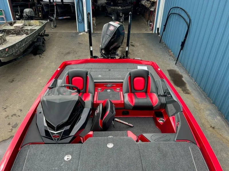 Slide: The Image of 2023 Ranger Z519 boat with red and black interior, docked in a marina. - 7