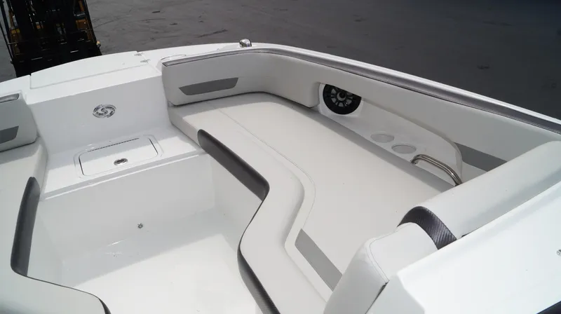 Slide: The Image of 2023 Hurricane SunDeck 235 OB boat interior with white seating and storage compartments. - 10