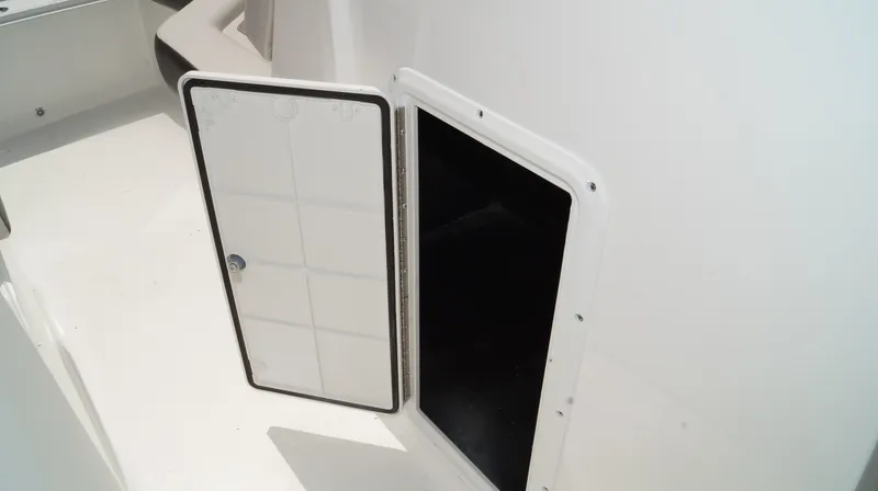 Slide: The Image of Open storage compartment on 2023 Hurricane SunDeck 235 OB boat. - 15