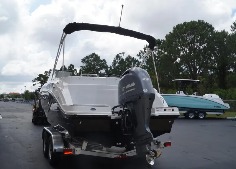 Slide: The Image of 2023 Hurricane SunDeck 235 OB boat with Yamaha 200 outboard motor on trailer. - 4