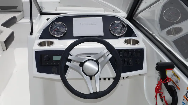 Slide: The Image of 2023 Hurricane SunDeck 235 OB boat dashboard with steering wheel and control panel. - 6