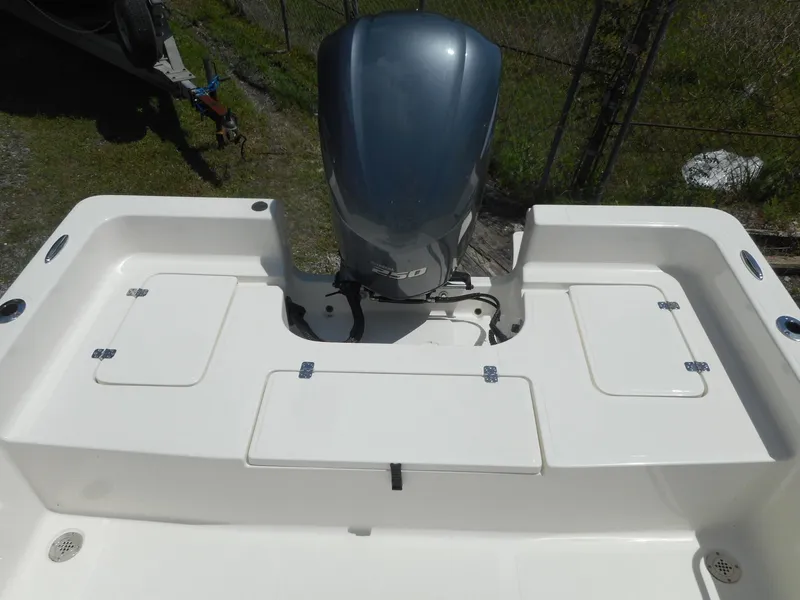 Slide: The Image of 2023 Bulls Bay 2400 boat stern with outboard motor and storage compartments. - 10