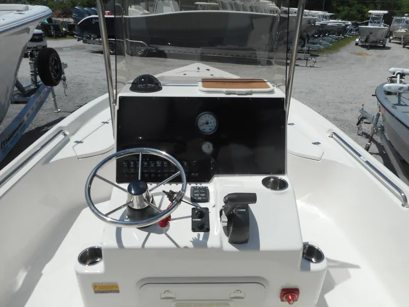 Slide: The Image of 2023 Bulls Bay 2400 boat console with steering wheel and controls. - 2