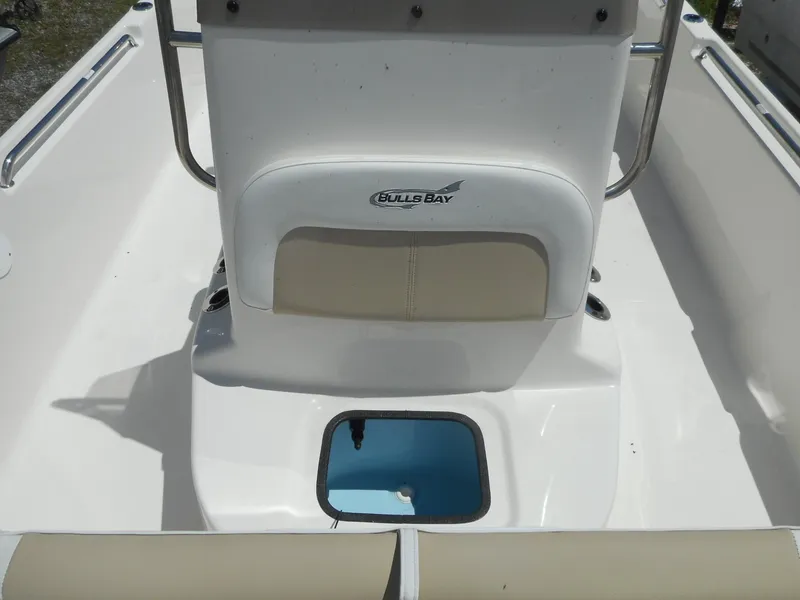 Slide: The Image of 2023 Bulls Bay 2400 boat interior with seating and storage compartment. - 7