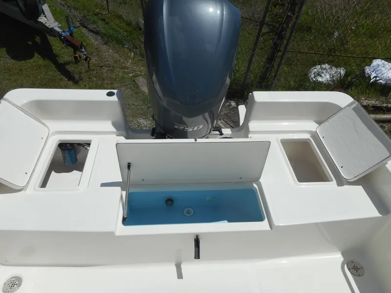 Slide: The Image of 2023 Bulls Bay 2400 boat stern with outboard motor and storage compartments. - 9