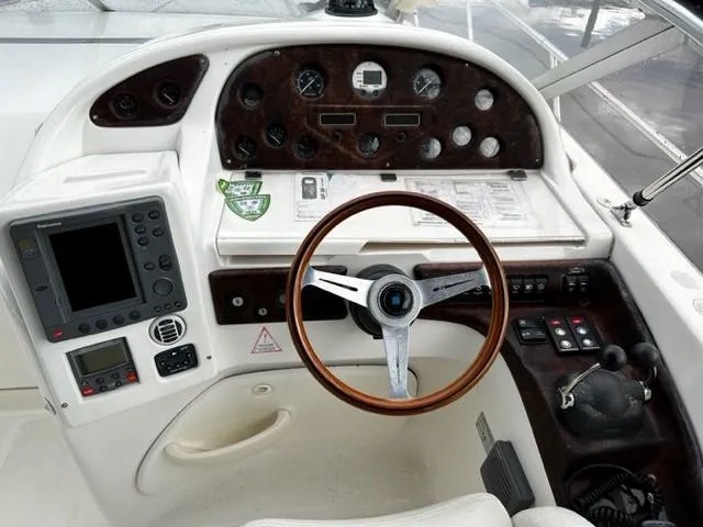 Slide: The Image of 2005 Cranchi 37 Smeraldo boat dashboard with steering wheel and navigation controls. - 17