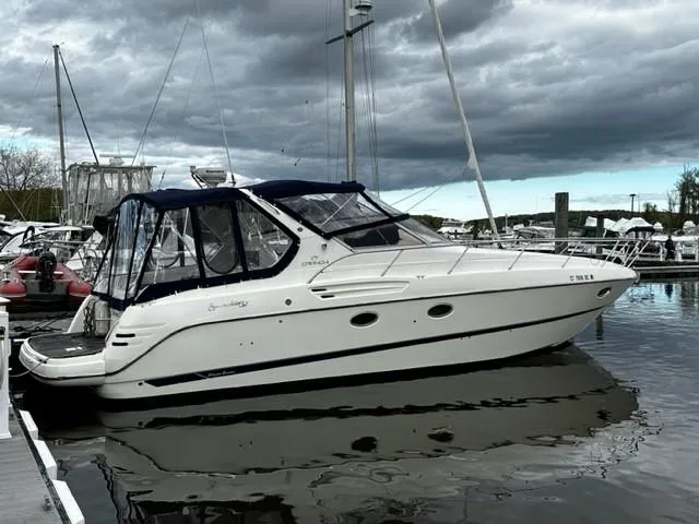 Slide: The Image of 2005 Cranchi 37 Smeraldo yacht docked at marina under cloudy sky. - 2