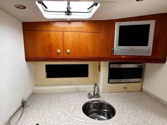 Slide: The Image of Interior of 2005 Cranchi 37 Smeraldo yacht kitchen with sink, cabinets, and appliances. - 28