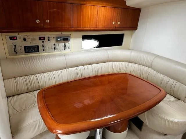 Slide: The Image of Interior of 2005 Cranchi 37 Smeraldo yacht with leather seating and wooden table. - 29