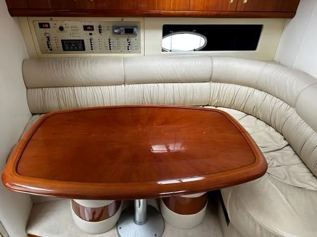 Slide: The Image of 2005 Cranchi 37 Smeraldo yacht interior with wooden table and beige leather seating. - 30
