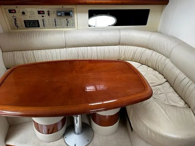 Slide: The Image of 2005 Cranchi 37 Smeraldo yacht interior with leather seating and wooden table. - 31