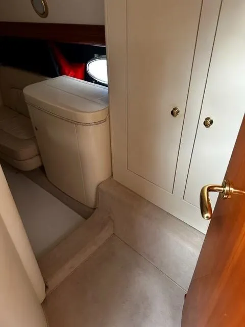 Slide: The Image of Interior of 2005 Cranchi 37 Smeraldo yacht, featuring elegant cabinetry and seating. - 32