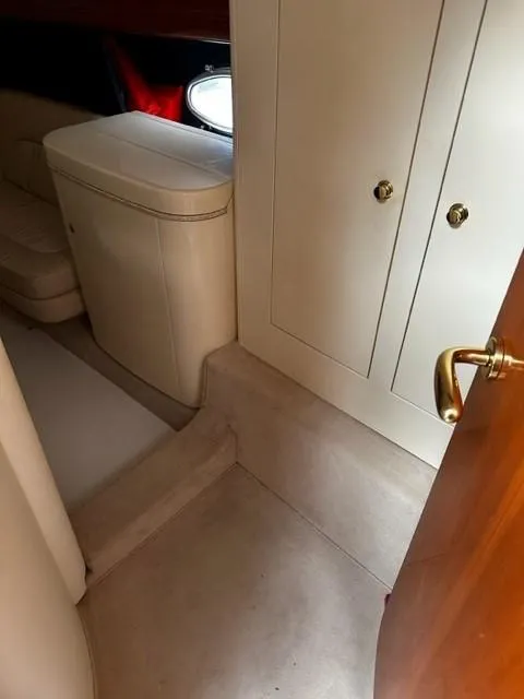 Slide: The Image of Interior of 2005 Cranchi 37 Smeraldo yacht, featuring elegant cabinetry and seating. - 33