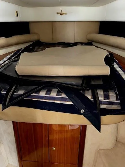Slide: The Image of 2005 Cranchi 37 Smeraldo cabin interior with folded bedding and storage. - 37