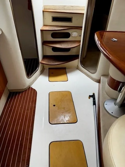 Slide: The Image of Interior of 2005 Cranchi 37 Smeraldo yacht with wooden steps and seating area. - 40