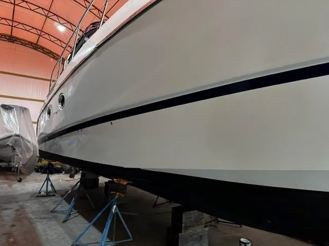 Slide: The Image of 2005 Cranchi 37 Smeraldo yacht in storage, side view, under maintenance indoors. - 44