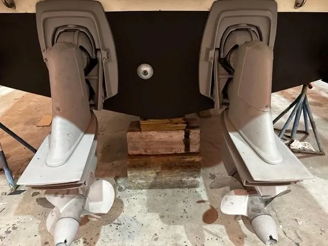 Slide: The Image of 2005 Cranchi 37 Smeraldo boat propellers and drives in a maintenance setting. - 47