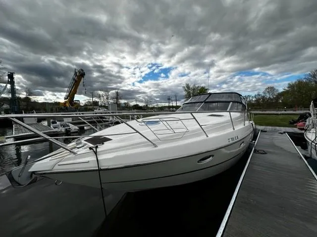 Slide: The Image of 2005 Cranchi 37 Smeraldo yacht docked under cloudy skies. - 6