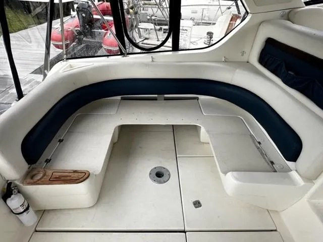 Slide: The Image of 2005 Cranchi 37 Smeraldo yacht interior with curved seating and white upholstery. - 8