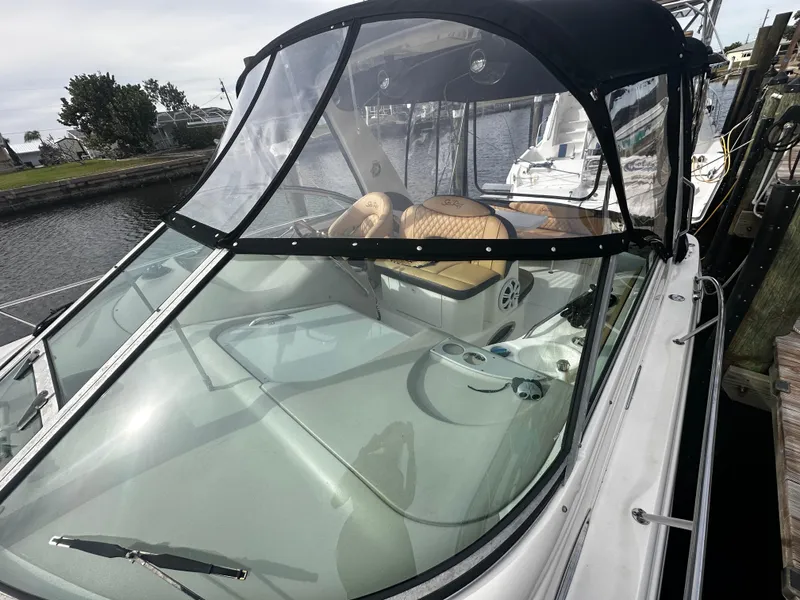 Slide: The Image of 2001 Sea Ray 340 Sundancer boat with enclosed cockpit docked. - 11