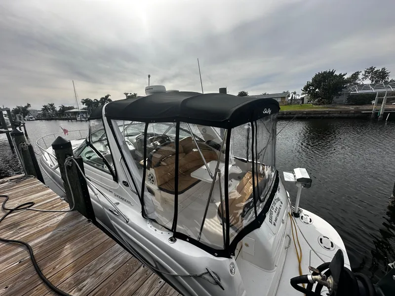 Slide: The Image of 2001 Sea Ray 340 Sundancer docked at a marina with a black canopy. - 13