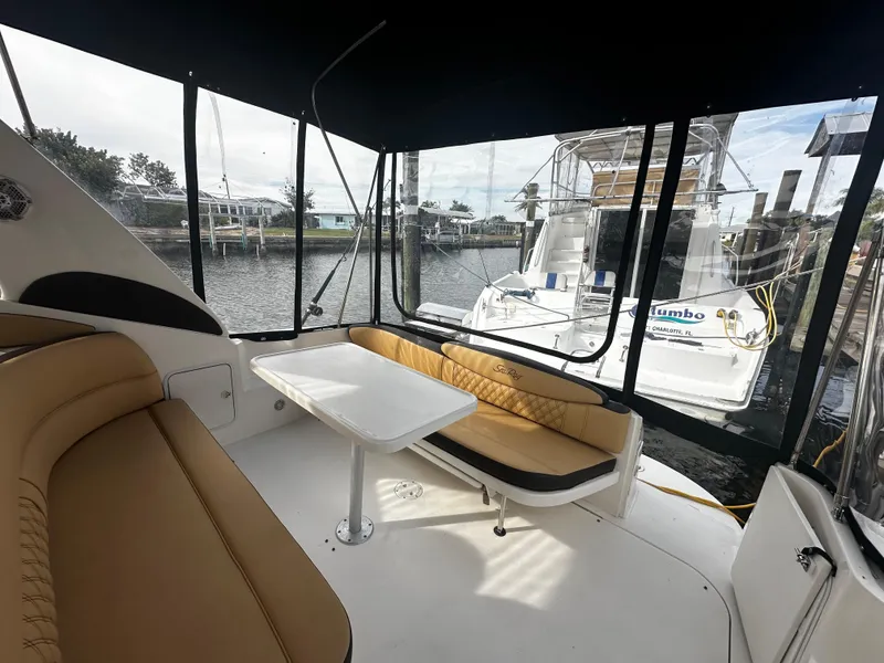 Slide: The Image of Interior view of 2001 Sea Ray 340 Sundancer yacht with tan seating and table. - 14