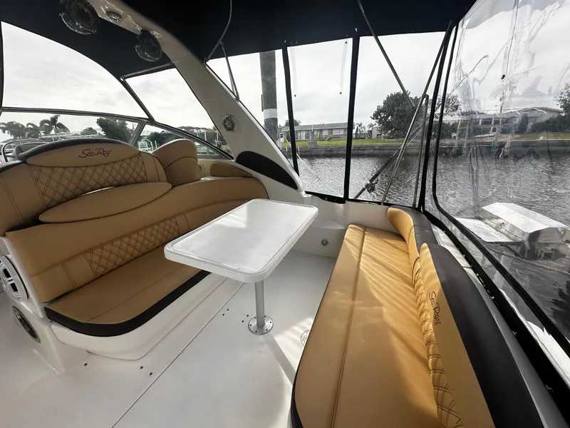 Slide: The Image of Interior of 2001 Sea Ray 340 Sundancer with tan leather seating and white table. - 15