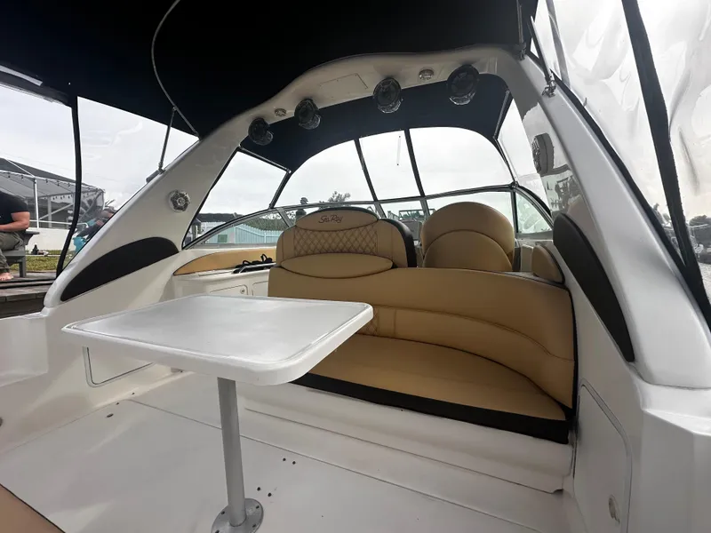 Slide: The Image of Interior of 2001 Sea Ray 340 Sundancer with tan seating and white table. - 16