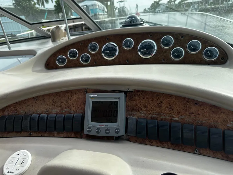 Slide: The Image of Dashboard of a 2001 Sea Ray 340 Sundancer boat with gauges and controls. - 24
