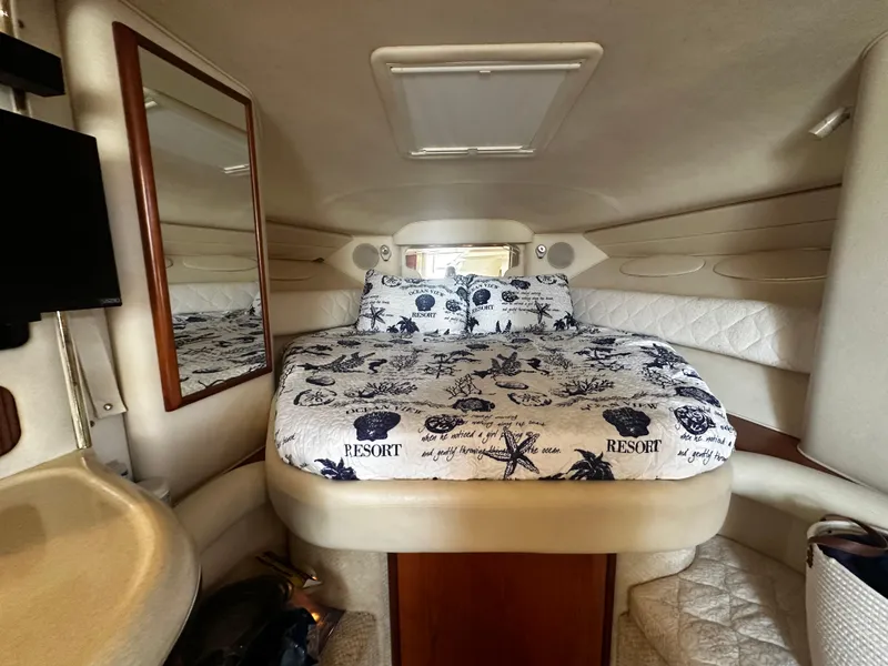 Slide: The Image of 2001 Sea Ray 340 Sundancer cabin interior with bed, mirror, and porthole. - 33
