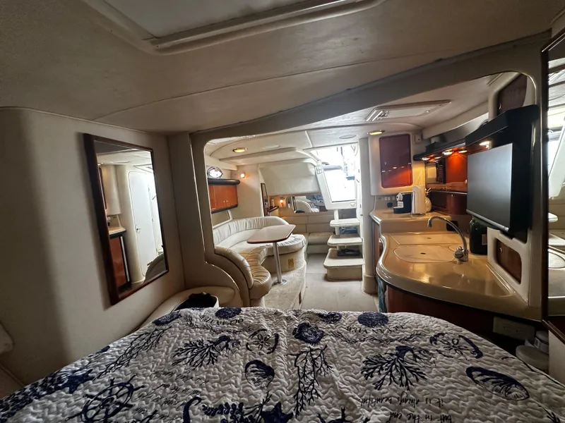 Slide: The Image of Interior of 2001 Sea Ray 340 Sundancer yacht with kitchen, seating, and bed. - 34