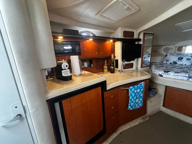 Slide: The Image of Interior of 2001 Sea Ray 340 Sundancer yacht with kitchenette and sleeping area. - 35