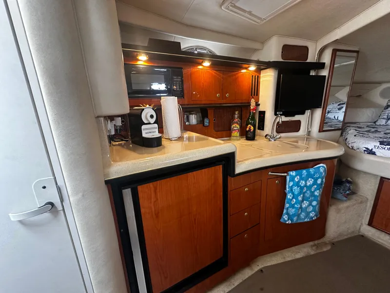 Slide: The Image of Interior of 2001 Sea Ray 340 Sundancer with kitchenette, microwave, and TV. - 36