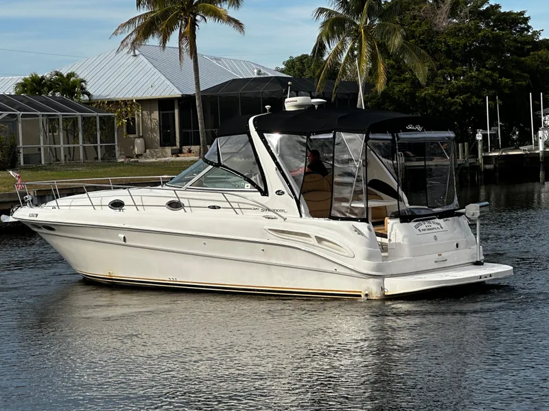 Slide: The Image of 2001 Sea Ray 340 Sundancer boat cruising on a calm waterway. - 4