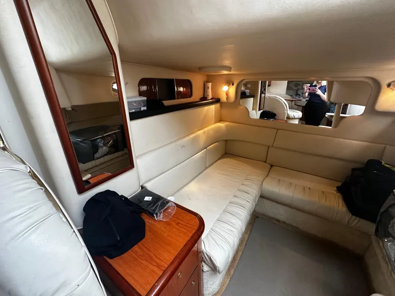 Slide: The Image of Interior of 2001 Sea Ray 340 Sundancer yacht with beige seating and wooden accents. - 40