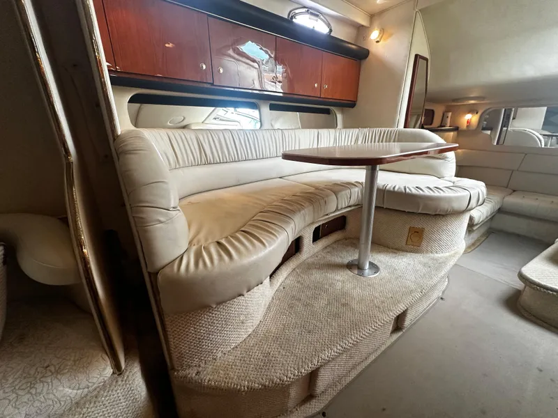Slide: The Image of 2001 Sea Ray 340 Sundancer interior with plush seating and wooden cabinetry. - 41