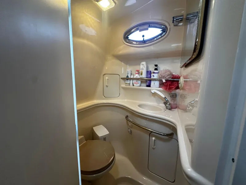 Slide: The Image of 2001 Sea Ray 340 Sundancer bathroom with sink, toilet, and storage shelves. - 43