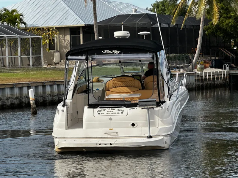Slide: The Image of 2001 Sea Ray 340 Sundancer cruising in a residential canal. - 6