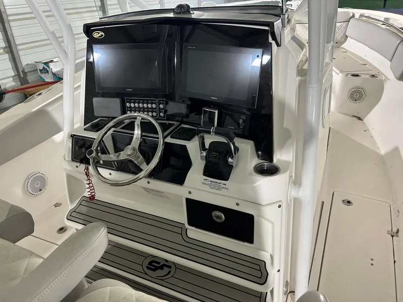 Slide: The Image of 2019 Sea Fox 328 Commander boat cockpit with dual screens and steering wheel. - 12
