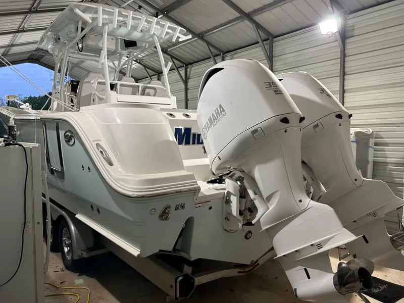 Slide: The Image of 2019 Sea Fox 328 Commander boat with dual Yamaha engines in a covered storage area. - 13