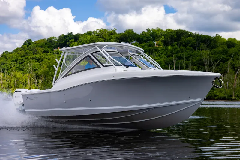 Slide: The Image of 2023 Albemarle 31 Dual Console boat cruising on a lake. - 0