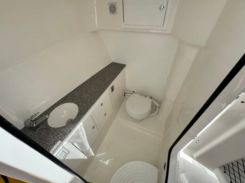 Slide: The Image of 2023 Albemarle 31 Dual Console boat bathroom with sink and toilet. - 10