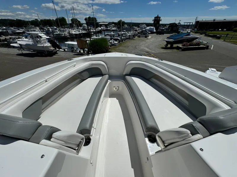 Slide: The Image of 2023 Albemarle 31 Dual Console boat with spacious seating at a marina. - 7