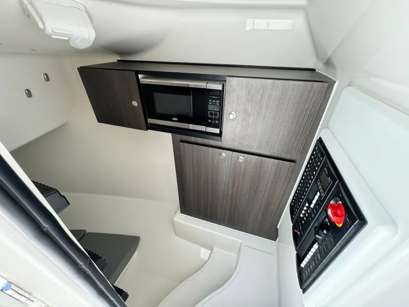 Slide: The Image of 2023 Albemarle 31 Dual Console interior with microwave and control panel. - 8