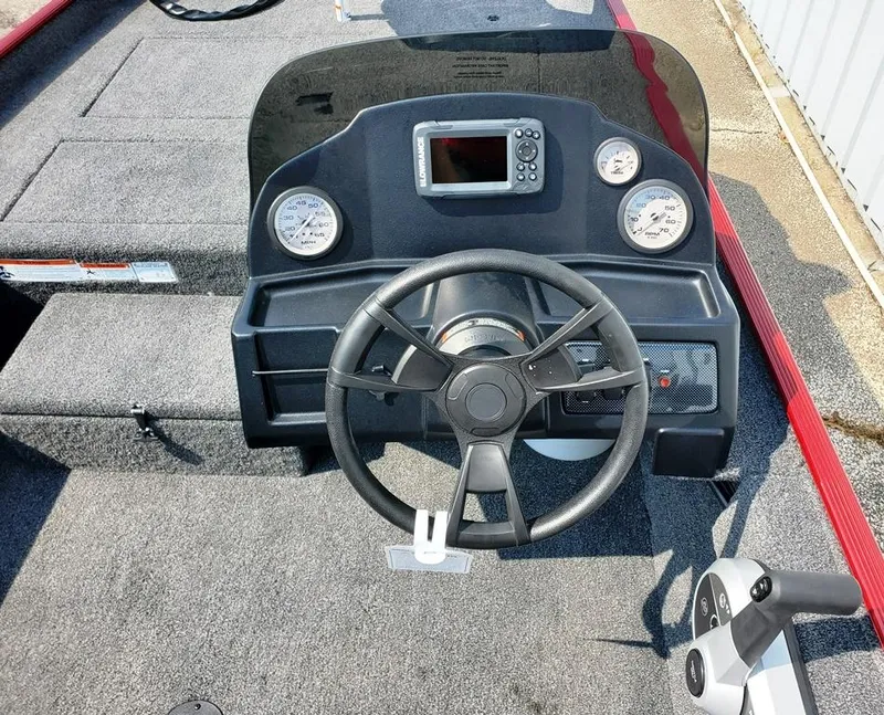Slide: The Image of 2023 Lowe Skorpion 17 boat dashboard with steering wheel and gauges. - 10
