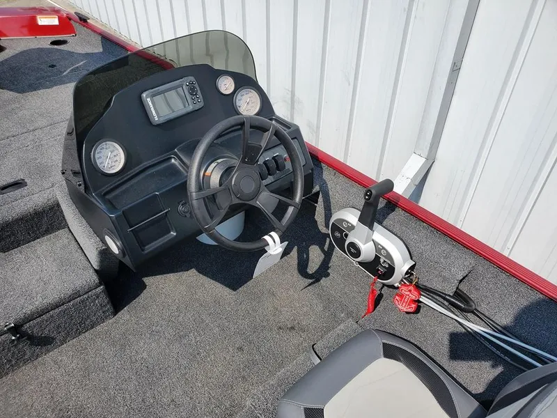 Slide: The Image of 2023 Lowe Skorpion 17 boat dashboard with steering wheel and control panel. - 3