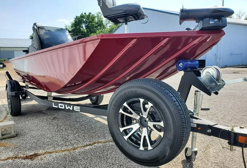 Slide: The Image of 2023 Lowe Skorpion 17 boat on trailer, red hull, close-up view. - 8