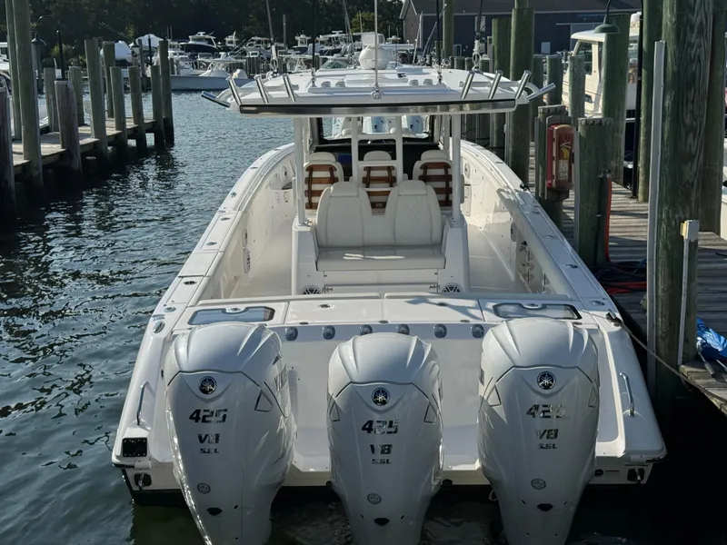 Slide: The Image of 2024 Everglades 395 Center Console boat docked with triple 425 V8 engines. - 13